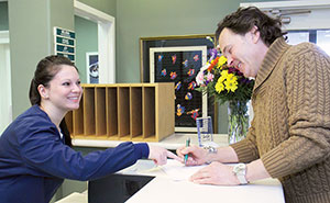 Freindly staff member helps patient with payment information