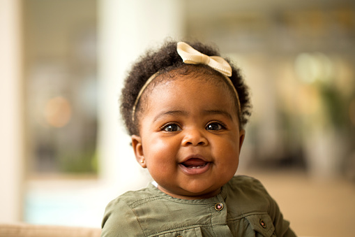 Black baby with teeth smiling after parents made appointment at Brush & Floss Dental Center in Stratford, CT