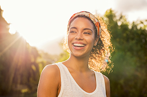 Beautiful Black woman smiling after appointment at Brush & Floss Dental Center in Stratford, CT