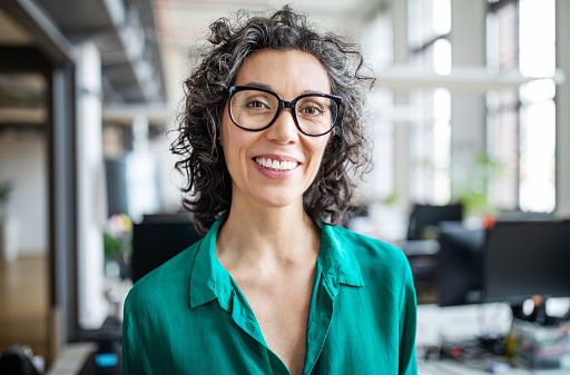 Woman with glasses smiling after visit to Brush & Floss Dental Center in Stratford, CT