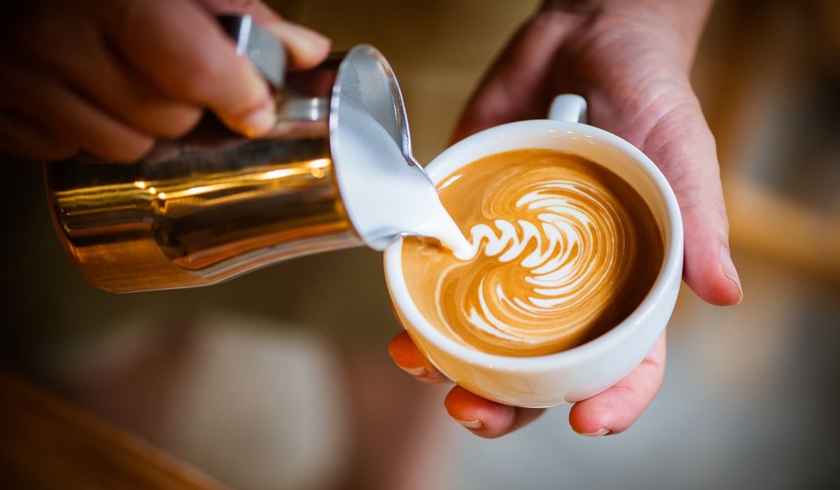 Coffee being poured with cream.