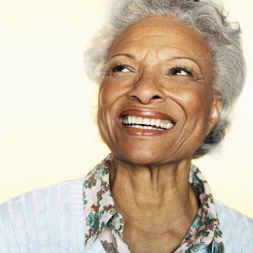 African American woman smiling with her new dental implants from Brush & Floss Dental Center in Stratford, CT