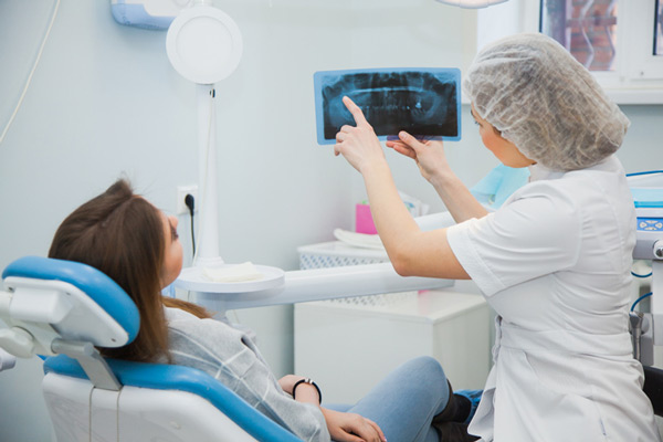 Dentist showing patient x ray atBrush & Floss Dental Center in Stratford, CT
