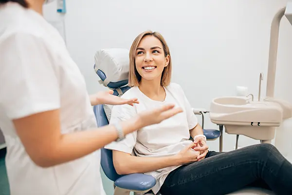 Dentist speaking with patient at Brush & Floss Dental Center in Stratford, CT