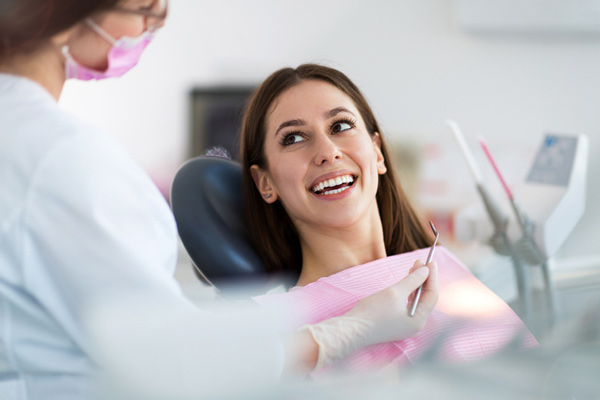 Woman smiling after getting an oral cancer screening at Brush & Floss Dental Center in Stratford, CT 