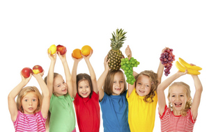 Children holding up healthy fruit at Brush & Floss Dental Center in Stratford, CT